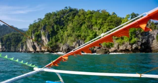 Our day in Puerto Princesa Philippines, began aboard local outrigger boats, landing on a serene sandy beach where curious long-tailed macaques greeted us. A short walk brought us to the safety gear station before embarking on a 200m trek through old-growth rainforest, where we spotted an Asian water monitor in the wild! 

We then boarded paddle boats for a float through breathtaking limestone caves. The chambers were adorned with stunning stalactites, home to 14 species of bats, all brought to life by our guide’s torch and insightful audio headsets.

Our guests were thrilled by this unique and unforgettable experience—a true highlight of the journey!